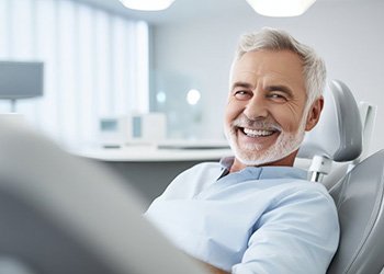 a patient smiling after receiving new dentures