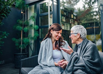 an older woman talking to another woman