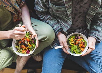 two people eating healthy meals