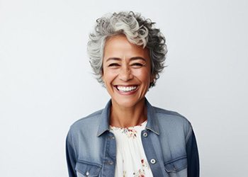 an older woman in denim smiling